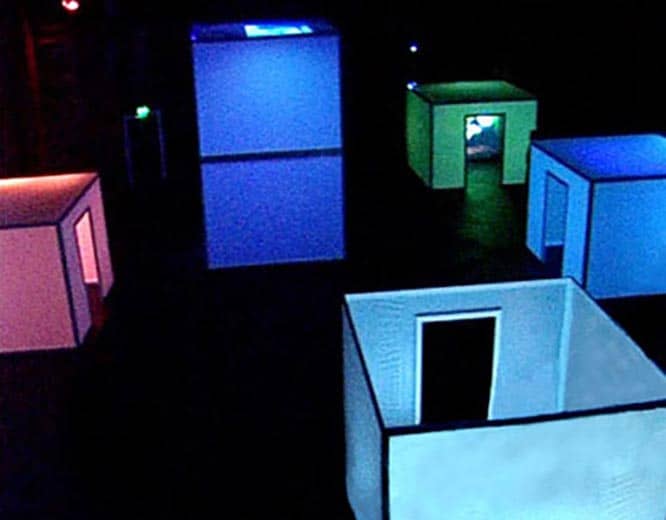 Dark space with multi-coloured cubes with projections