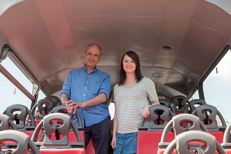 David Wheeler and Joanne Wain from IOU stand for photography on the Rear View bus