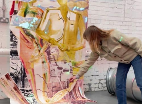 Woman paint large colourful canvas